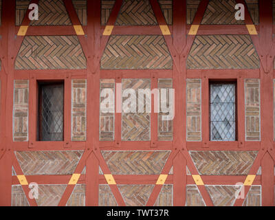 Detail of Gothic Half-Timbered Burgrave's House on Karlstejn Castle or Karluv Tyn in Bohemia Czech Republic. A Red Brick Facade with Wooden Timbering. Stock Photo