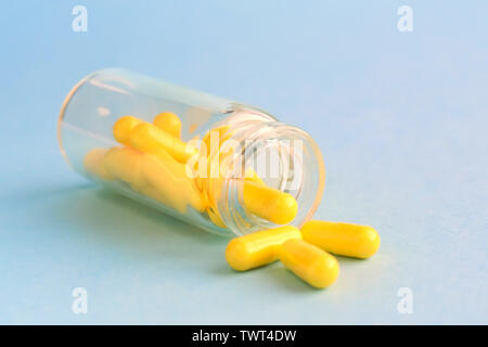Download Yellow Capsules From Glass Bottle On Blue Background Copyspace For Text Epidemic Painkillers Healthcare Treatment Pills And Drug Abuse Concept Stock Photo Alamy PSD Mockup Templates