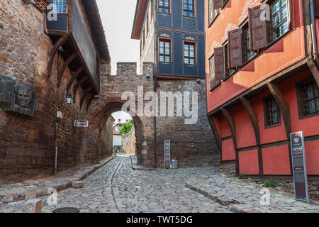 Hisar Kapia medieval gate in Plovdiv's old town built in the 11th century AD and old houses in plovdiv old town bulgaria Stock Photo