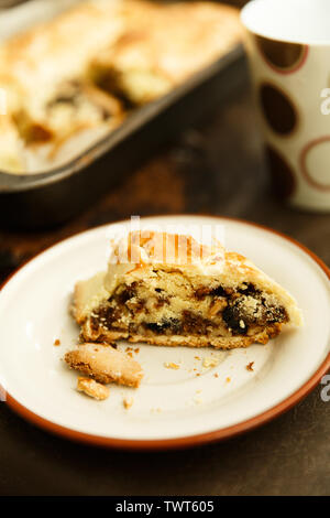 raisin roll with nuts. A piece of cake on a saucer Stock Photo