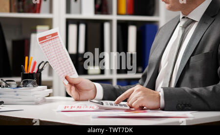 Businessman working and calculating, reads and writes reports. Office employee, table closeup. Business financial accounting concept. Stock Photo