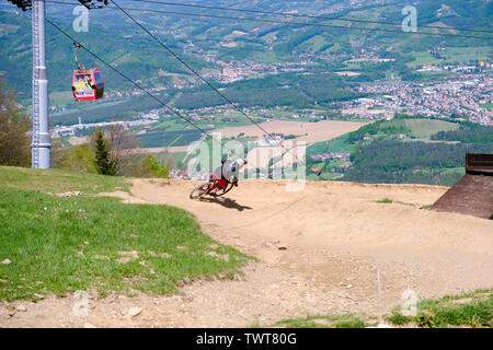 Maribor, Slovenia - May 2, 2019: Downhill mountain bikers riding down the trail on Pohorje near Maribor, Slovenia. Pohorje bike park is very popular Stock Photo