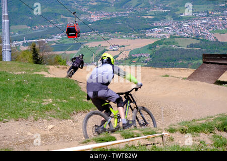 Maribor, Slovenia - May 2, 2019: Downhill mountain bikers riding down the trail on Pohorje near Maribor, Slovenia. Pohorje bike park is very popular Stock Photo