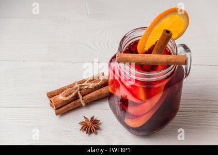 Mulled wine and spices on white wooden background. Selective focus Stock Photo