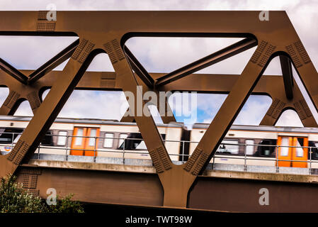 Diagonal view of a train passing at speed on the GE19 Bridge, Shoreditch, London, UK Stock Photo