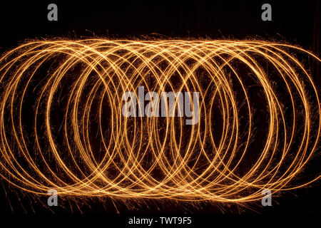 Sparkle multiple circle shape. Burning fire sparklers isolated on black. Stock Photo