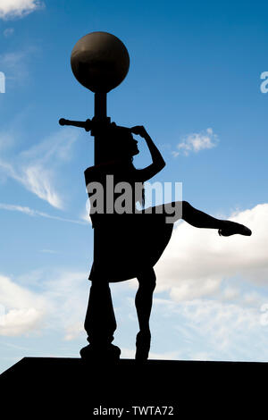 London, England, UK - Silhouette of a ballerina leaning against a lamppost along the river Thames against a blue sky background Stock Photo