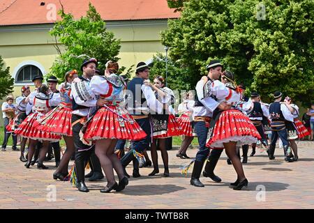 Brno - Bystrc, Czech Republic, June 22, 2019. Traditional Czech feast. Folk Festival. Girls and boys dancing in beautiful costumes. An old Christian h Stock Photo