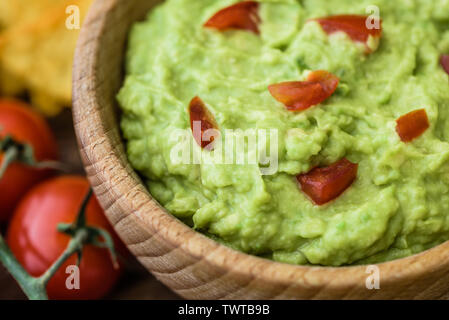 Close Up Detail of Guacamole in Wooden Bowl Stock Photo