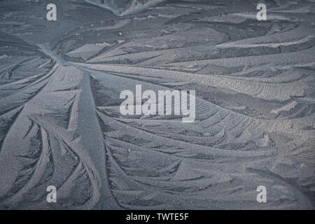 Swirling patterns made by wind in frost on car roof. Stock Photo