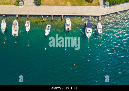 Aerial view of yachts and sailboats in marina in Sibenik, Croatia. White boats in blue sea water. Stock Photo