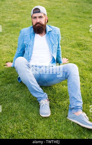 Brutal handsome hipster man resting on summer day. Bearded man trendy hipster style. Guy modern outfit. Casual and comfortable. Hipster lifestyle. Cool hipster with beard wear stylish baseball cap Sto...