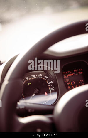 Close up of a steering wheel with remote control, blurry dashboard Stock Photo