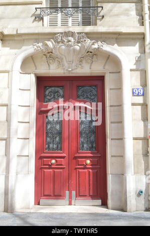 Antique red door at Champs-Élysées street in Paris, France Stock Photo