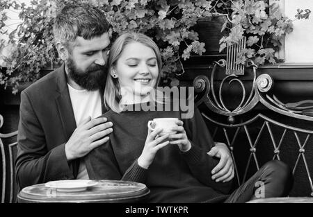 Travel and vacation. Explore cafe and public places. Couple cuddling cafe terrace. Couple in love sit cafe terrace enjoy coffee. Pleasant family weekend. Married lovely couple relaxing together. Stock Photo