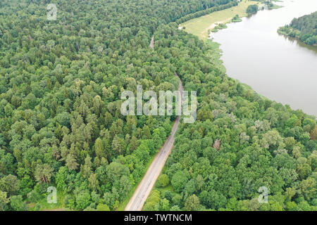 Photo from quadrocopter drone air forest road for traveling along river. Ecological route concept Stock Photo