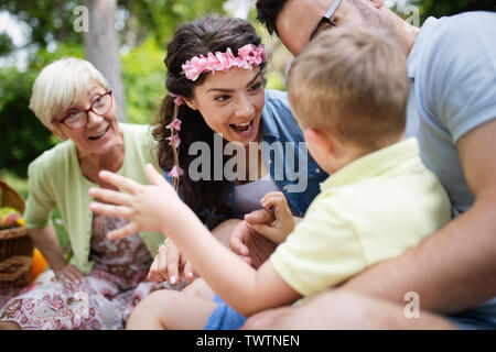 Multi generation family enjoying picnic in a park Stock Photo