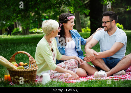 Happy family having picnic in park outdoors Stock Photo