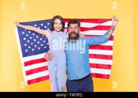 Happy to be americans. Happy independence day. Bearded man and little girl happy smiling with american flag. Happy family celebrating independence day. Stock Photo