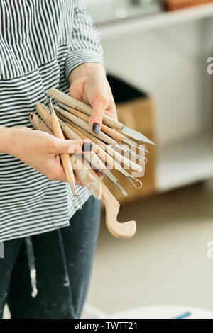 pottery tools for carving ceramic products in workshop Stock Photo