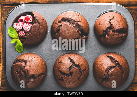 Tasty Chocolate Muffins In Baking Tin. Table Top View. Toned Image