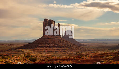 Monument Valley under the Fullmoon light in spring. Red rocks against blue sky in the evening. Navajo Tribal Park in the Arizona-Utah border, United S Stock Photo