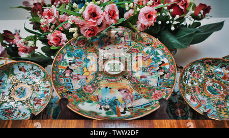 Chinese rose medallion porcelain plates with pink flowers in a decorative still life Stock Photo
