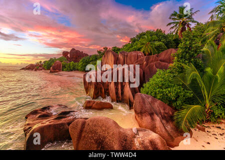 Dramatic colorful sky at twilight at scenic Anse Source d'Argent Beach in Seychelles, La Digue. Aerial view of amazing landscape with huge shaped rock Stock Photo