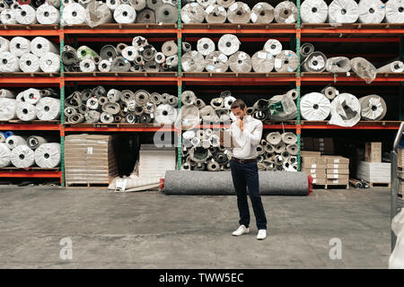 Warehouse manager using a clipboard while doing inventory Stock Photo