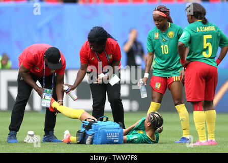 Cameroon's Estelle Johnson (centre) receives treatment during the FIFA Women's World Cup, round of Sixteen match at State du Hainaut, Valenciennes. Stock Photo