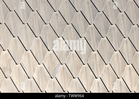 Abstract background of diamond shapes of close up detail of lead tiles on a roof in the summer sunshine Stock Photo