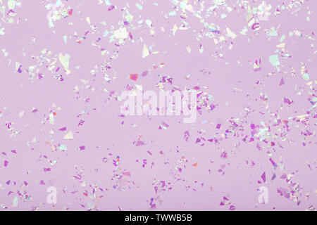 Red glowing mica sparkles on violet pastel trendy abstract background. Stock Photo