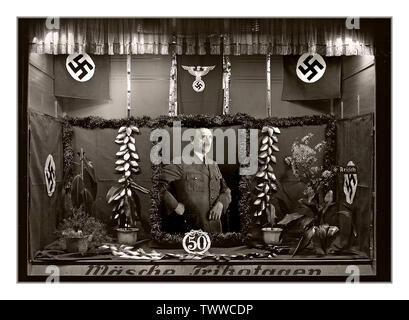 Vintage 1939 Adolf Hitler shop window display celebrating his 50th Birthday On 18 April 1939, the government of Germany declared that their Führer Adolf Hitler's birthday (20 April) was to be a national holiday. Festivities took place in all municipalities throughout the country. Stock Photo