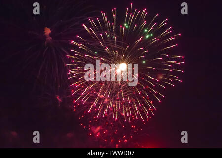 Long Exposure of Fireworks Against a Black Sky . Background of multi-colored salute and fireworks closeup on a black background Stock Photo