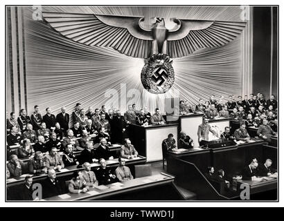 Adolf Hitler PODIUM REICHSTAG SPEECH Vintage pre-war 1930's German Nazi Propaganda Image of German Chancellor Adolf Hitler (standing at lectern) delivering a speech at the Reichstag on the 'Jewish question,' threatening the annihilation of European Jewry should another war break out, 30 January 1939. Adolf Hitler – Führer and Reich Chancellor of Germany and Leader of the Nazi Party Germany Stock Photo