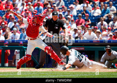 Philadelphia, Pennsylvania, USA. 23rd June, 2019. Philadelphia Phillies catcher Andrew Knapp (15) reaches as he tags out Miami Marlins first baseman Garrett Cooper (26) at home during the MLB game between the Miami Marlins and Philadelphia Phillies at Citizens Bank Park in Philadelphia, Pennsylvania. Christopher Szagola/CSM/Alamy Live News Stock Photo