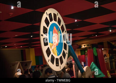 A reel for a ViewMaster with scenes from Disney's Peter Pan with his picture on the front. This area is in a Toy Story ride waiting area. Stock Photo