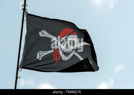 Jolly Roger skull and crossbones black pirate flag Stock Photo