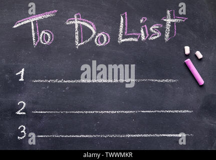 Handwriting text with white and pink chalk on black board Stock Photo