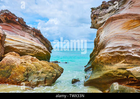 Enjoy Andaman seascape through the giant red rocks at the shore of Khai Nai island, Phuket, Thailand Stock Photo