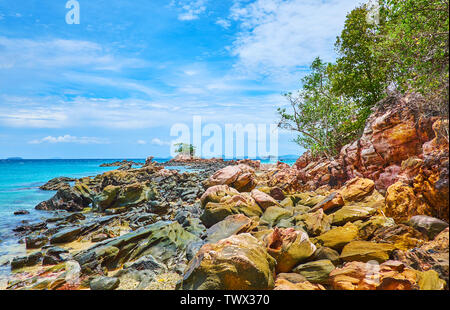 The boulders of distroyed rock formation cover the shoreline of Khai Nai island, Phuket, Thailand Stock Photo