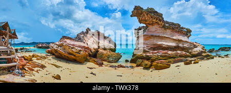 Panorama of the sandy golden coast of Khai Nai island with beautiful red weathered rocks, Phuket, Thailand Stock Photo