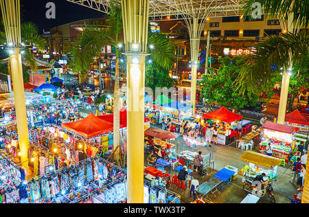 PATONG, THAILAND - MAY 1, 2019: Banzaan Night Bazaar in bright evening lights with lots of food stalls, offering local dishes and cool drinks, on May Stock Photo