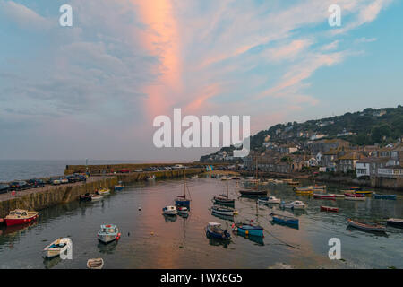 Mousehole, Cornwall, UK. 23rd June 2019. UK Weather. Heavy rain during the day cleared to give a fine end to the day in the far south west of Cornwall at Mousehole at sunset. Credit Simon Maycock / Alamy Live News. Stock Photo