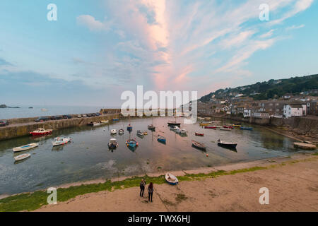 Mousehole, Cornwall, UK. 23rd June 2019. UK Weather. Heavy rain during the day cleared to give a fine end to the day in the far south west of Cornwall at Mousehole at sunset. Credit Simon Maycock / Alamy Live News. Stock Photo