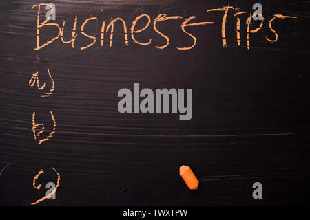 Business Tips written with color chalk. Supported by an additional services. Blackboard concept Stock Photo