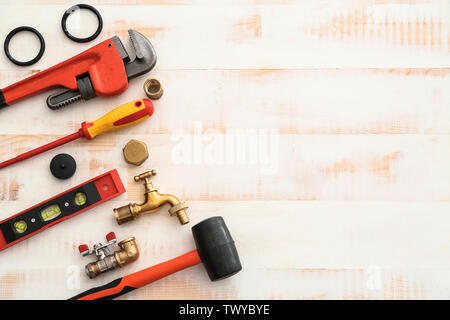 Set of plumbing tools on white wooden background Stock Photo