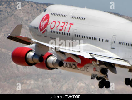 Mojave, California, USA. 23rd June, 2019. Virgin Orbit 747 Cosmic Girl comes in for landing after 4hr test run Sunday morning from Mojave airport California, June 23, 2019. Under it's left wing is the LauncerOne rocket that getting ready for it's first test drop this year. The 747 did a series of test of Zoom Climb Maneuvers off the coast of SoCal and will be leading up to the 1st launch test. Photo by Gene Blevins/ZUMAPRESS Credit: Gene Blevins/ZUMA Wire/Alamy Live News