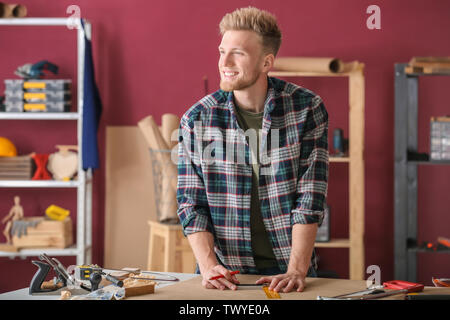 Male carpenter working in shop Stock Photo