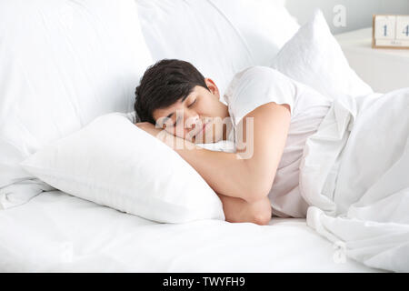 Handsome young man sleeping in bed Stock Photo